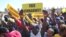 FILE - Supporters of Zimbabwe's main opposition leader Nelson Chamisa hold placards upon his arrival for a a rally on the outskirts of Harare on July 17, 2023.