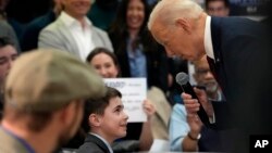 U.S. President Joe Biden talks to Harry Abramson during a visit to the Biden campaign office in Milwaukee, Wisconsin, March 13, 2024. 