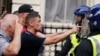 Protesters confront police officers during a protest in Whitehall, London, on July 31, 2024, following the fatal stabbing of three children at a dance and yoga class on Monday in Southport.