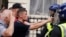 Protesters confront police officers during a protest in Whitehall, London, on July 31, 2024, following the fatal stabbing of three children at a dance and yoga class on Monday in Southport.