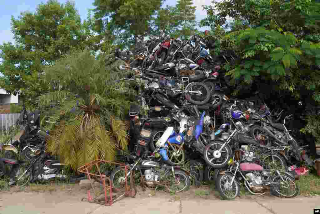 Motorcycles that were seized by police for being allegedly stolen lay in a pile at the municipal police in Asuncion, Paraguay.