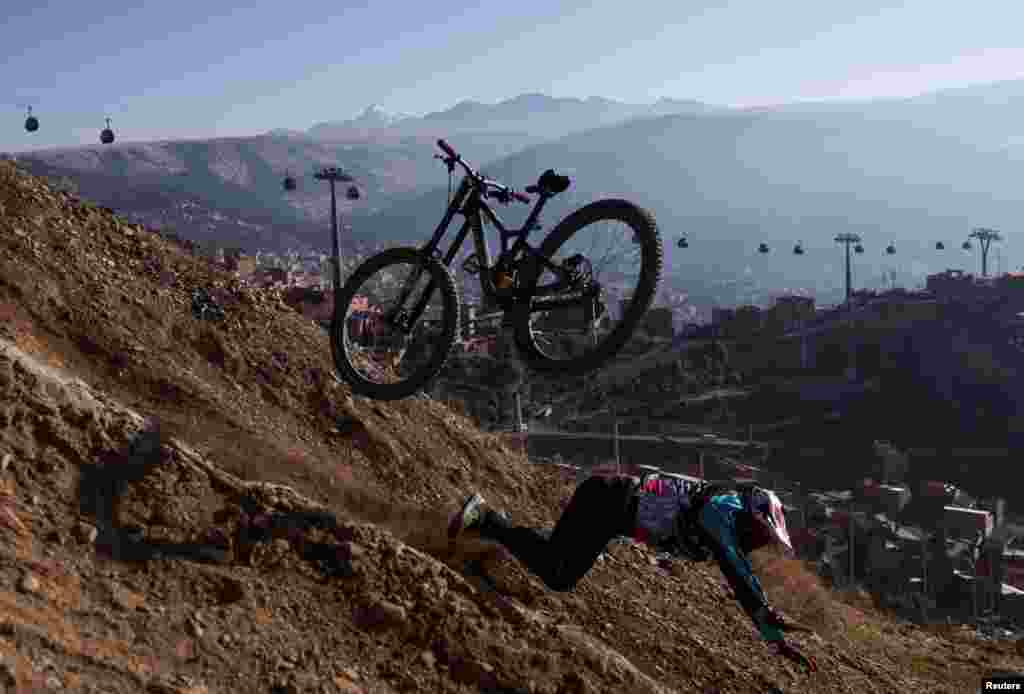 A cyclist falls during his practice ahead of the Challenge Downhill mountain biking race, in La Paz, Bolivia, June 30, 2024. 
