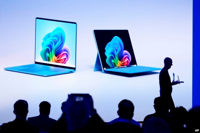 Brett Ostrum, Microsoft corporate vice president of Surface, shows a new Surface Laptop and Surface Pro with built-in AI during an event at Microsoft headquarter,s Monday, May 20, 2024, in Redmond, Wash. (AP Photo/Lindsey Wasson)