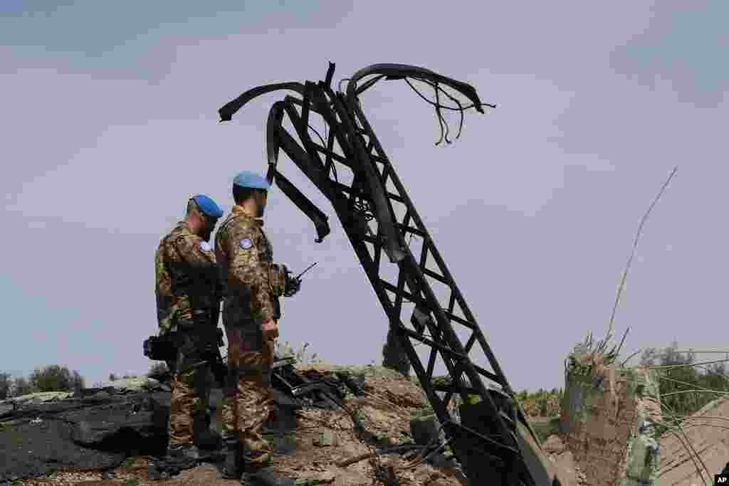 Italian U.N. peacekeeper soldiers inspect a small bridge that was destroyed by an Israeli airstrike, in Maaliya village, south Lebanon.