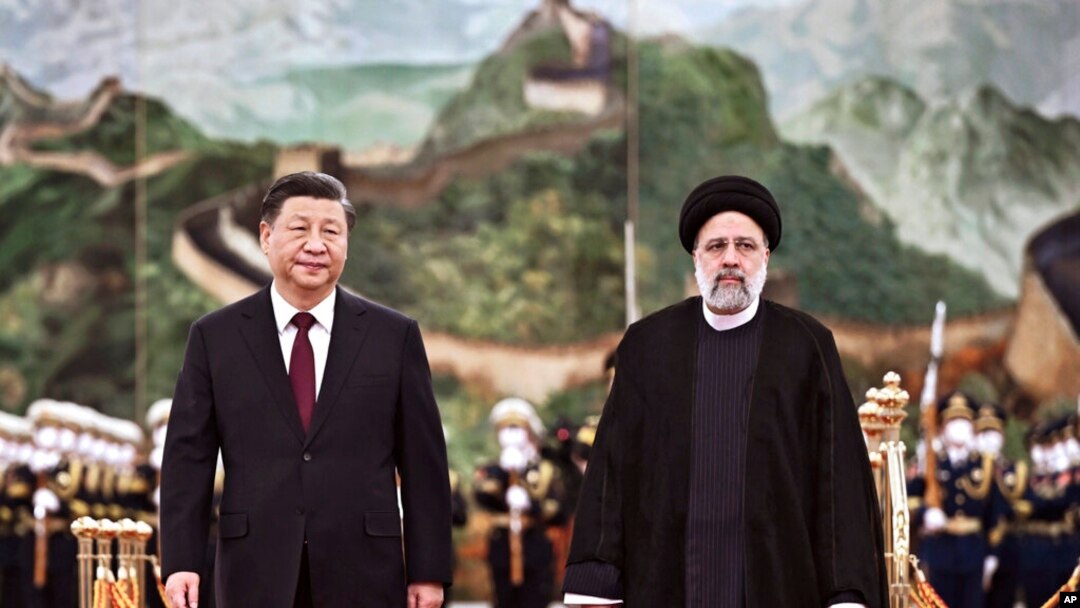 FILE - Visiting Iranian President Ebrahim Raisi walks with Chinese President Xi Jinping after reviewing an honor guard during a welcome ceremony at the Great Hall of the People in Beijing, Feb. 14, 2023. (Xinhua via AP)