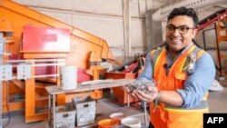 We Recycle Solar Chief Executive Office, Adam Saghei shows metals removed from solar panels to be recycled t the We Recycle Solar plant in Yuma, Arizona, Dec. 6, 2023. (Photo by VALERIE MACON / AFP)