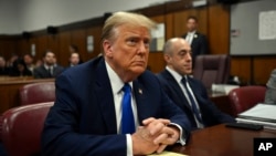 Former President and Republican presidential candidate Donald Trump looks on at Manhattan criminal court during his trial in New York, April 22, 2024. Opening statements in Trump's historic hush money trial are set to begin.