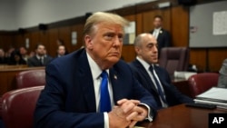 FILE - Former President Donald Trump looks on at Manhattan criminal court during his trial in New York, April 22, 2024. 