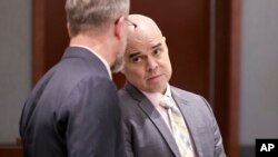 Robert Telles, right, a former Clark County public administrator charged in the murder of journalist Jeff German, talks with attorney Robert Draskovich during a break in his trial at the Regional Justice Center in Las Vegas, Aug. 16, 2024.