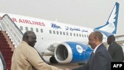 A handout picture provided by Sudan's Transitional Sovereignty Council on August 29, 2023, shows Sudanese Army chief and the council's chairman General Abdel Fattah al-Burhan (R) boarding an airplane heading for Egypt at Port Sudan's airport. 