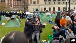 Полицейские Нью-Йорка арестовывают протестующего в палаточном лагере на кампусе Колумбийского университета. Нью-Йорк. 18 апреля 2024 года. 