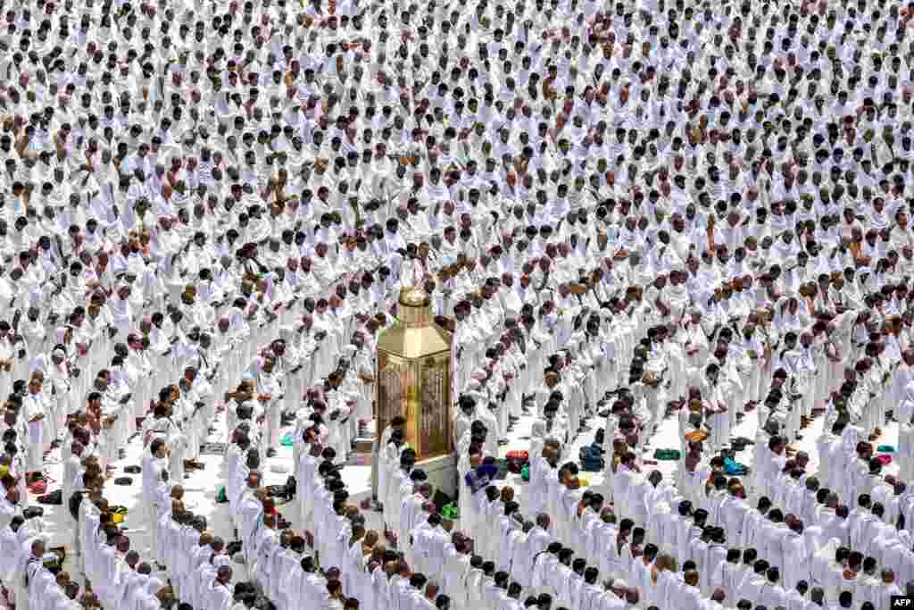 Muslim worshippers stand around Maqam Ibrahim (Station of Abraham) as they pray, at the Grand Mosque in the holy city of Mecca during the second Friday prayers in the holy month of Ramadan.