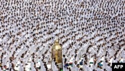 Muslim worshippers stand around Maqam Ibrahim (Station of Abraham) as they pray, at the Grand Mosque in the holy city of Mecca during the second Friday prayers in the holy month of Ramadan.
