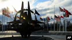 FILE - NATO country members flags wave at NATO headquarters in Brussels, on Nov. 28, 2023.