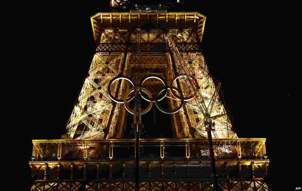 The Olympic rings are put in place on the Eiffel Tower for the upcoming 2024 Olympic Games, in Paris