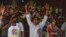 Fans of Indian superstar Rajinikanth, cheer at a cinema hall as they celebrate the screening of his latest film, 'Jailer,' in Mumbai, India, Aug. 10, 2023. 