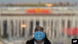 A soldier dressed as an usher stands guard at an entrance door of the Great Hall of the People in Beijing, March 3, 2023.