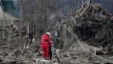 A medical worker comforts a woman at the site of Russia's air attack, in Zaporizhzhia, Ukraine.