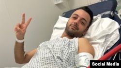 Pouria Zeraati, a presenter for independent Persian-language outlet Iran International, flashes a victory sign in a photo he posted of himself on X March 30, 2024, while hospitalized after a stabbing attack.