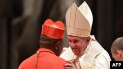 Pope Francis (R) embraces new Cardinal Congolese prelate Fridolin Ambongo Besungu at St. Peter's Basilica in the Vatican on October 5, 2019.