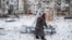 A woman walks on a playground after an apartment block was heavily damaged by a missile strike, amid Russia's attack on Ukraine, in Pokrovsk, Donetsk region, Feb. 15, 2023.