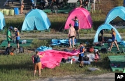 Attendees of the World Scout Jamboree prepare to leave a scout camping site in Buan, South Korea, Aug. 8, 2023. (Newsis via AP)