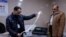 Officials work after the close of the polling station during Iraq's provincial council elections, in Mosul, Iraq Dec. 18, 2023.