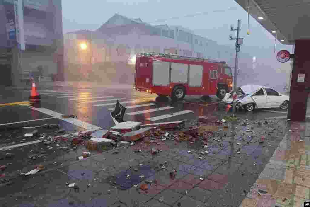 In this photo taken on July 24, 2024 and released by Hualien Fire Department, show a car being hit by falling walls after Typhoon Gaemi made landfall in Hualien county, Taiwan.