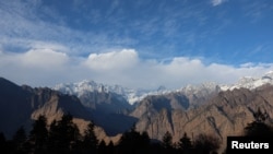 FILE - Snow-capped mountains mark the skyline in Joshimath, in the northern state of Uttarakhand, India, Jan. 15, 2023.