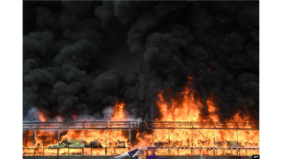 A burning pile of seized illegal drugs is seen during a destruction ceremony to mark the 'International Day against Drug Abuse and Illicit Trafficking' in Yangon on June 26, 2023.