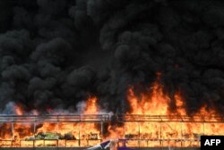 A burning pile of seized illegal drugs is seen during a destruction ceremony to mark the 'International Day against Drug Abuse and Illicit Trafficking' in Yangon on June 26, 2023.