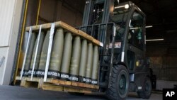 FILE - Airmen use a forklift to move 155 mm shells ultimately bound for Ukraine on April 29, 2022, at Dover Air Force Base in Delaware. The Biden administration on Aug. 10, 2023, requested an additional $13 billion in emergency defense aid for Ukraine.