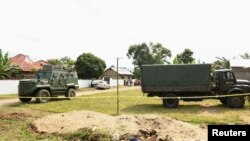 FILE - Ugandan security forces cordon the scene outside the Mpondwe Lhubirira Secondary School, after militants linked to the rebel Allied Democratic Forces killed and abducted multiple people, in Mpondwe, western Uganda, June 17, 2023. 