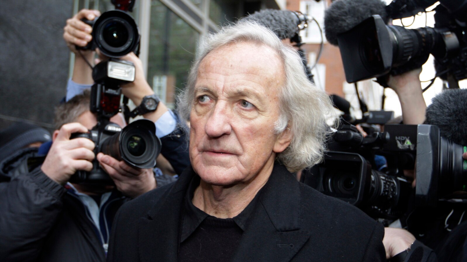 FILE - Journalist, John Pilger, a supporter of Wikileaks founder Julian Assange arrives at the City of Westminster Magistrates Court in London where Julian Assange is in court for his bail hearing, Tuesday, Dec. 14, 2010.