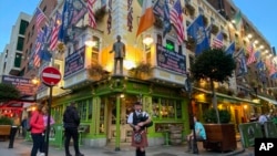 FILE - A bagpiper plays in front of the Oliver St. John Gogarty bar in the Temple Bar district of Dublin, Ireland, Aug. 24, 2023. The Biden administration is planning to construct a new U.S. embassy in Ireland.