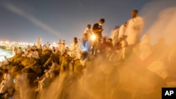 Muslim pilgrims gather at top of the rocky hill known as the Mountain of Mercy, on the Plain of Arafat, during the annual Hajj pilgrimage, near the holy city of Mecca, Saudi Arabia, June 15, 2024. 