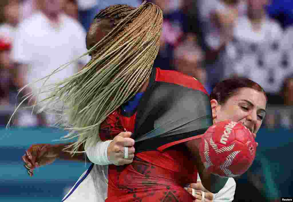 Azenaide Carlos of Angola tackles with Tamara Horacek of France during the 2024 Summer Olympics women&#39;s handball preliminary round group B match at the South Paris Arena 6 in Paris, France.