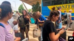 FILE - French nationals gather as they wait to be airlifted back to France on a French military aircraft, at the international airport in Niamey, Niger, Aug. 1, 2023.