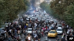 FILE - Protesters chant slogans during a demonstration over the death of a woman who was detained by the morality police, in Tehran, Iran, on Sept. 21, 2022.