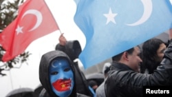 FILE - Ethnic Uyghur demonstrators wave flags of Turkey and East Turkestan during a protest against China, near the Chinese Consulate in Istanbul, Feb. 5, 2023.