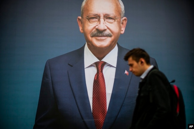 A man walks past a billboard of Turkish CHP party leader and Nation Alliance's presidential candidate Kemal Kilicdaroglu a day after the presidential election day, in Istanbul, Turkey, Monday, May 15, 2023. (AP Photo/Emrah Gurel)
