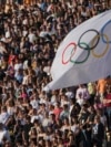 The Olympic flag flies during the Olympic flame handover ceremony, April 26, 2024, in Athens, at Panathenaic stadium, where the first modern games were held in 1896.