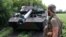 FILE - Ukrainian marines check their French-made AMX-10 RC armored fighting vehicle at a position in the Donetsk region on July 10, 2023.
