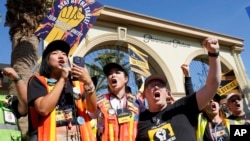 FILE - SAG-AFTRA leaders cheer for striking actors outside Paramount Pictures studio, in Los Angeles, Nov. 3, 2023. Hollywood's video game performers voted to go on strike July 25, 2024, throwing part of the entertainment industry into another work stoppage.