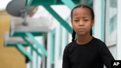 Ezekiel West, 10, stands for a portrait outside his home in Los Angeles on Sunday, Jan. 15, 2023. (AP Photo/Damian Dovarganes)