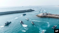 Iranian Revolutionary Guard speedboats move during a drill in the Persian Gulf, Aug. 2, 2023. The Guard began a surprise military drill Wednesday on disputed islands in the Persian Gulf. (Sepahnews via AP)