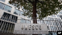 FILE - The United Nations Educational Scientific and Cultural Organization logo is pictured on the entrance at UNESCO's headquarters in Paris, Oct. 17, 2016. 