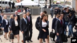 Representatives of Dominion Voting Systems arrive at the justice center in Wilmington, Del., for the Dominion Voting Systems' defamation lawsuit against Fox News, Tuesday, April 18, 2023.