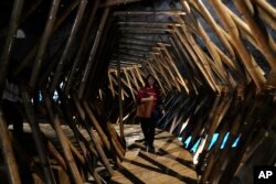 A woman walks inside an installation at the Philippine pavilion, at the Biennale International Architecture exhibition, in Venice, Italy, May 17, 2023.