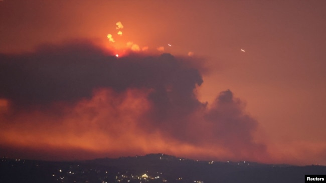 A view shows smoke on the Lebanese side of the border with Israel, after Israel said it had carried out pre-emptive strikes on Hezbollah targets in Lebanon, as seen from Tyre, southern Lebanon, Aug. 25, 2024.